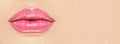 Beautiful young woman`s lips closeup, on beige background. Plastic surgery, fillers, injection. Part of the model girl face