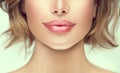 Beautiful young woman`s lips closeup. Plastic surgery, fillers, injection. Part of the model girl face, youth concept