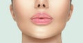 Beautiful young woman`s lips closeup. Plastic surgery, fillers, injection. Part of the model girl face, youth concept