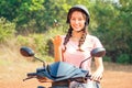 Beautiful and young woman in a safety helmet sitting on a motorcycle bike and holds the keys. concept of safe driving a