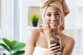 Beautiful young woman with scrub mask in spa salon Royalty Free Stock Photo