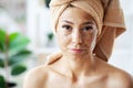 Beautiful young woman with scrub mask in spa salon Royalty Free Stock Photo