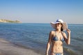 Beautiful young woman in sexy bikini standing at sea beach Royalty Free Stock Photo