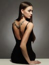 Beautiful young woman in dress and jewelry Royalty Free Stock Photo