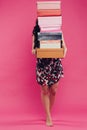 Beautiful young woman with shopping bags and boxes isolated on pink. Royalty Free Stock Photo