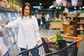 Beautiful young woman shopping for cereal, bulk in a grocery supermarket Royalty Free Stock Photo