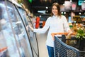 Beautiful young woman shopping for cereal, bulk in a grocery supermarket Royalty Free Stock Photo