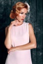 Beautiful young woman with short red hair in retro style,wears elegant white dress Royalty Free Stock Photo