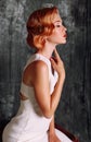 Beautiful young woman with short red hair in retro style,wears elegant white dress Royalty Free Stock Photo