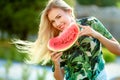 Beautiful young woman showing a slice of watermelon. She is caucasian. Summer and lifestyle concepts. Royalty Free Stock Photo