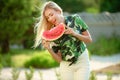 Beautiful young woman showing a slice of watermelon. She is caucasian. Summer and lifestyle concepts. Royalty Free Stock Photo