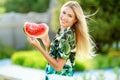 Beautiful young woman showing a slice of watermelon. She is caucasian. Summer and lifestyle concepts. Royalty Free Stock Photo