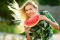 Beautiful young woman showing a slice of watermelon. She is caucasian. Summer and lifestyle concepts. Royalty Free Stock Photo