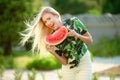 Beautiful young woman showing a slice of watermelon. She is caucasian. Summer and lifestyle concepts. Royalty Free Stock Photo