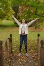 Beautiful young woman shown in park during fall