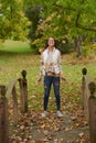 Beautiful young woman shown in park during fall