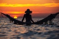 Beautiful young woman silhouette with swing posing in the sea on sunset, maldivian romantic scenery