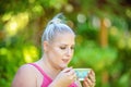 Beautiful Young Woman Sipping Tea In The Garden Royalty Free Stock Photo