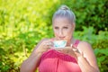 Beautiful Young Woman Sipping Tea In The Sun Royalty Free Stock Photo