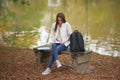 Beautiful young woman sits on college campus in fall alone Royalty Free Stock Photo