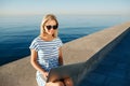 Beautiful young woman sitting on beach with laptop smiling and c Royalty Free Stock Photo