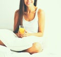 Beautiful young woman sitting in bed and having breakfast Royalty Free Stock Photo