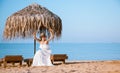 Beautiful young woman sitting on the bench on the beach Royalty Free Stock Photo