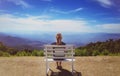 Beautiful young woman sitting on a bench at Doi Inthanon National Park Royalty Free Stock Photo