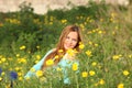 Beautiful young woman sitting in meadow Royalty Free Stock Photo