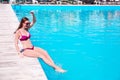 Beautiful young woman sitting near pool Royalty Free Stock Photo