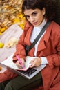 Woman with notebook and laptop in forest stock photo Royalty Free Stock Photo