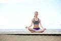 Beautiful young woman sitting outdoors in yoga pose Royalty Free Stock Photo