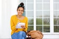 Beautiful young woman sitting outside writing in book Royalty Free Stock Photo