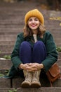 Beautiful young woman sitting on stairs outdoors Royalty Free Stock Photo