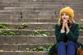 Beautiful young woman sitting on stairs outdoors Royalty Free Stock Photo