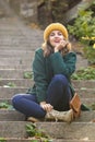 Beautiful young woman sitting on stairs outdoors Royalty Free Stock Photo