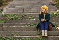 Beautiful young woman sitting on stairs outdoors Royalty Free Stock Photo