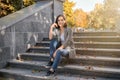 Beautiful young woman sitting on stairs outdoors Royalty Free Stock Photo