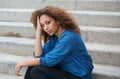 Beautiful young woman sitting on stairs outdoors Royalty Free Stock Photo