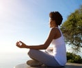 Beautiful young woman sitting in yoga pose at beach Royalty Free Stock Photo