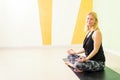 Beautiful young woman sitting in yoga position and meditating Royalty Free Stock Photo