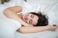 Beautiful young woman sleeping on bed