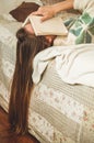 Beautiful young woman sleeping on bed with book covering her face because reading book with preparing exam of college Royalty Free Stock Photo