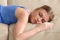 Beautiful young woman sleeping on couch at home, headshot portra