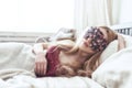 Beautiful young woman sleeping in her bed at home with blindfold eye mask. Royalty Free Stock Photo