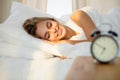 Beautiful young woman sleeping while lying in bed comfortably and blissfully Sunbeam dawn on her face Royalty Free Stock Photo