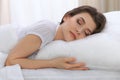 Beautiful young woman sleeping while lying in her bed and relaxing comfortably. It is easy to wake up for work or the Royalty Free Stock Photo