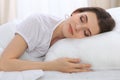 Beautiful young woman sleeping while lying in her bed and relaxing comfortably. It is easy to wake up for work or the Royalty Free Stock Photo