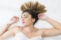 Beautiful young woman sleeping in a white bed with tatoo of bird Royalty Free Stock Photo