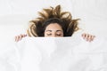 Beautiful young woman sleeping in a white bed. cover with Royalty Free Stock Photo